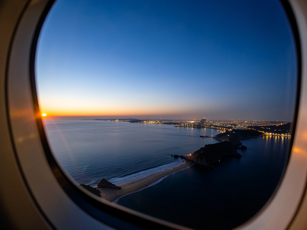 Aerial view coastline distant city lights dusk from