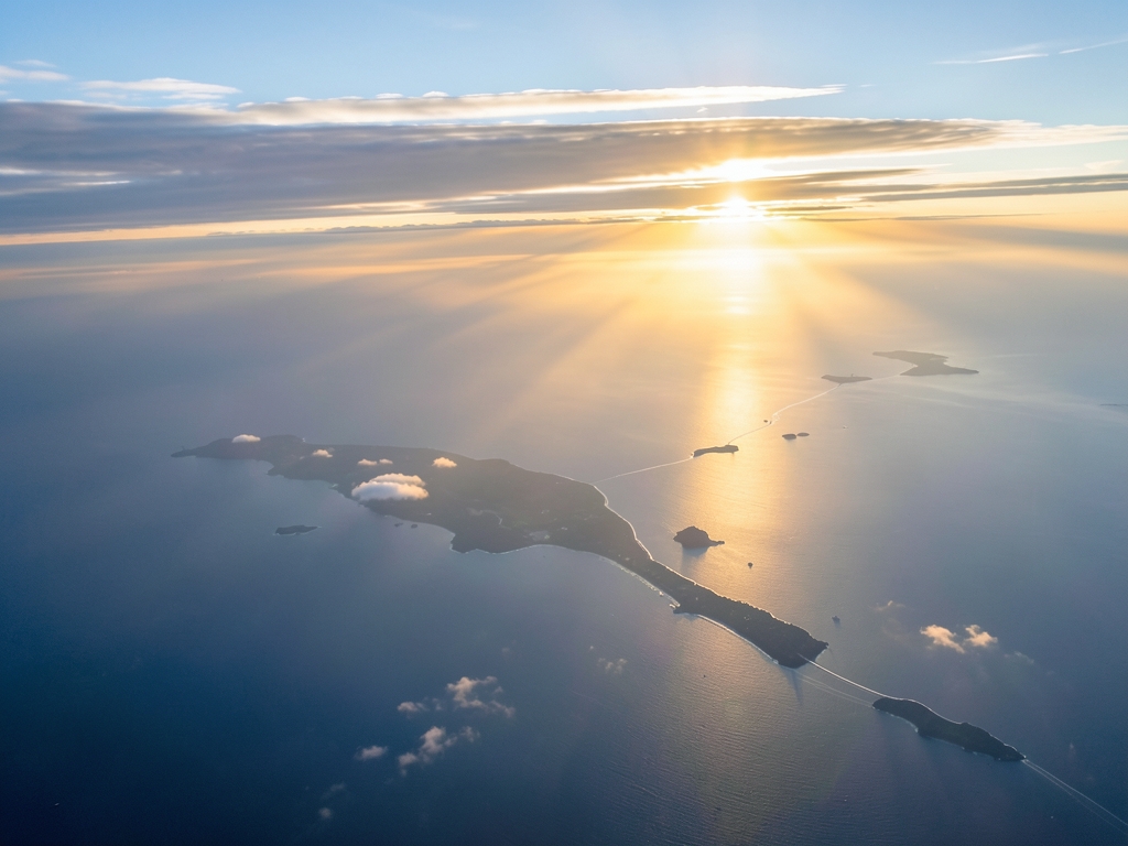 Aerial view long haul route arcing over Pacific sunrise