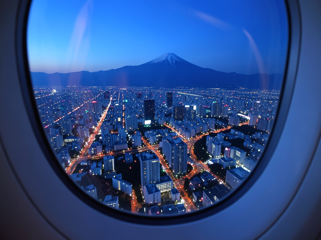 Tokyo skyline blue hour viewed from airplane window