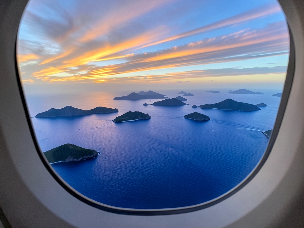 high altitude view from airplane window over vast ocean