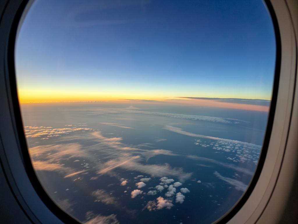 transatlantic flight path over North Atlantic dusk wispy