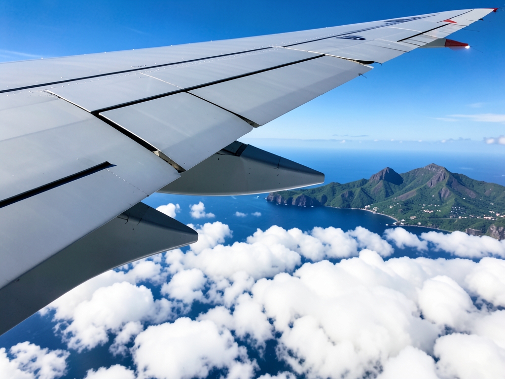 Airplane wing above bright white clouds over deep