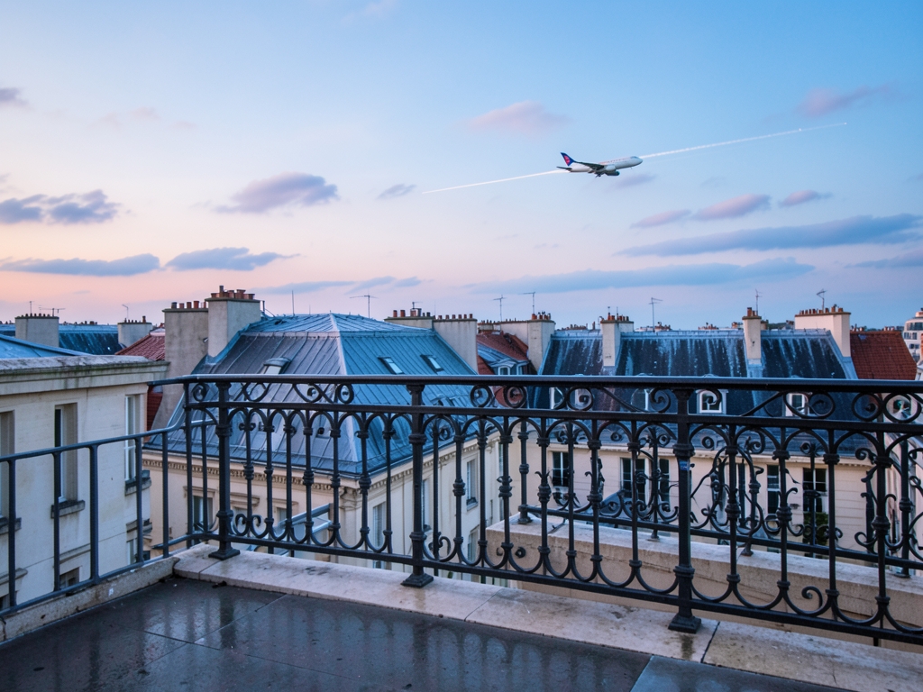 quiet Paris arrival terrace pale stone wrought iron