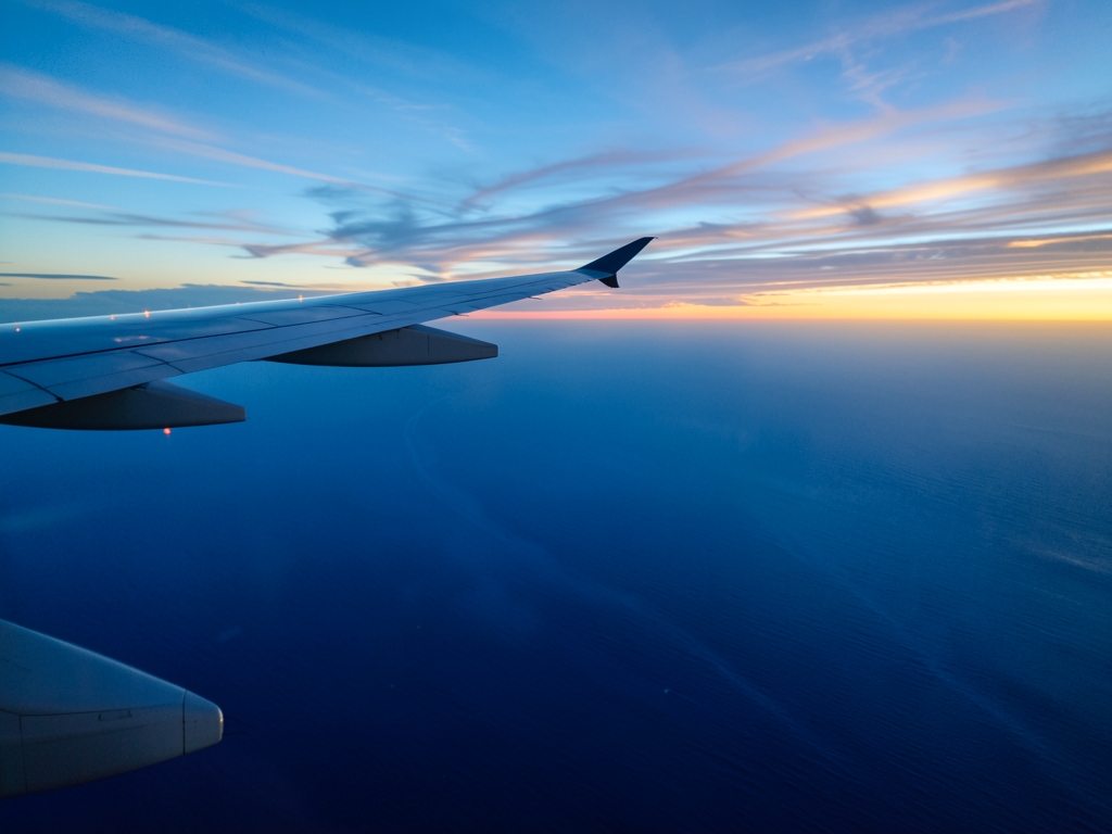 transatlantic flight over ocean twilight wingtip view with