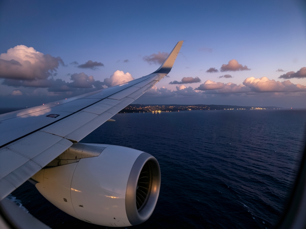 Airplane wing engine over dark Atlantic Ocean twilight