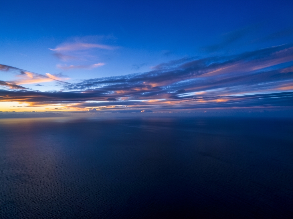 sweeping high altitude view over North Atlantic blue hour
