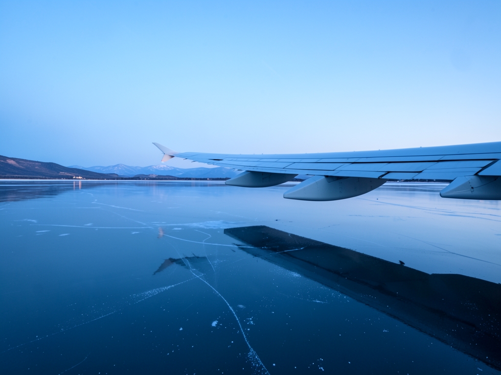 Wide angle view sleek modern aircraft wing gliding over