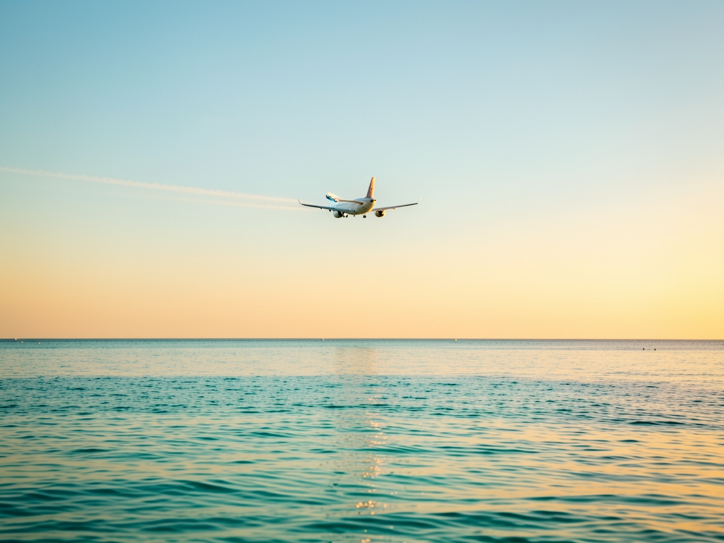 Warm golden hour light reflecting calm turquoise ocean