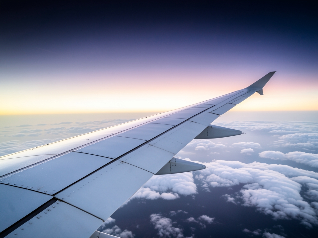 Transatlantic journey motif curved white wing slicing above