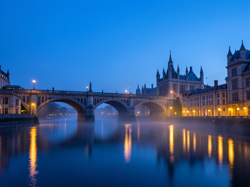 London riverside blue dusk with historic stone bridges