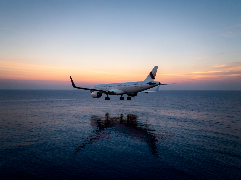 commercial glides over dark Atlantic Ocean twilight silhouette