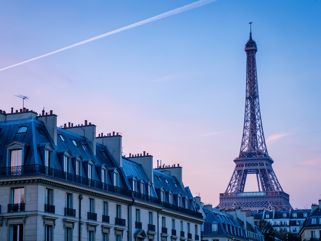 Paris Haussmann rooftops iron lattice tower silhouette blue