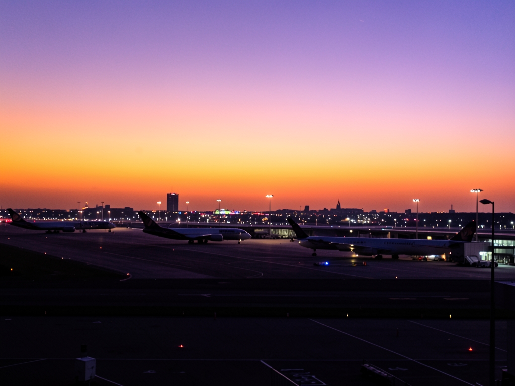 London Heathrow runway dusk with aircraft silhouettes against