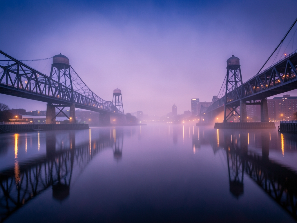 Misty Newark waterfront twilight reflecting steel bridges water
