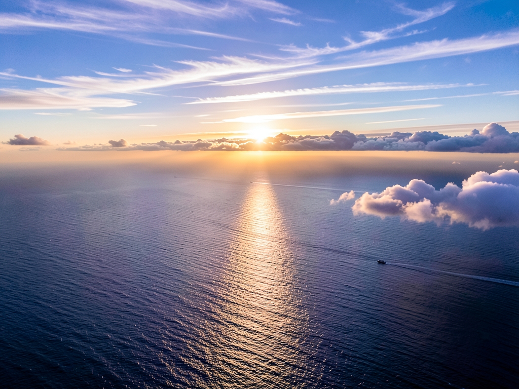high altitude view over Atlantic Ocean sunrise with layered