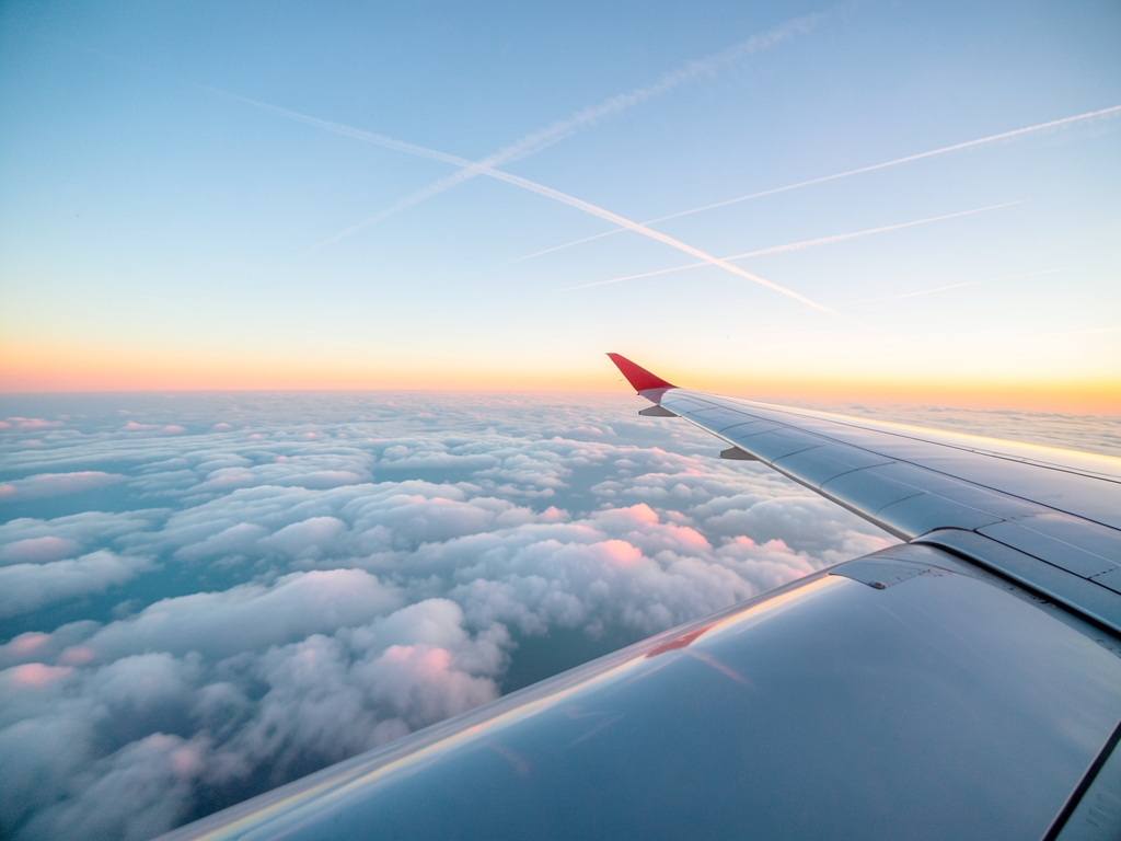 Aerial view above clouds sunrise rose gold light