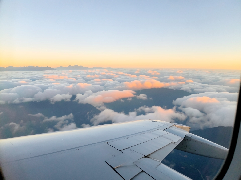 Airplane wing seen from window seat above soft