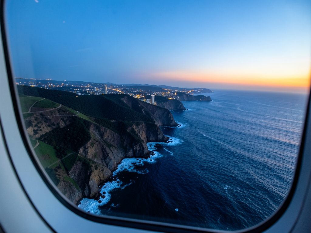 Aerial view Pacific coastline sunset from aircraft window