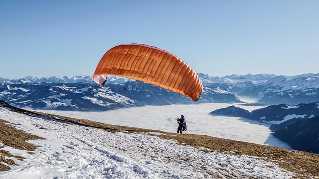 paraglider flying paragliding freedom leisure time activity sea of fog snow flight preparation nature flight weather mou