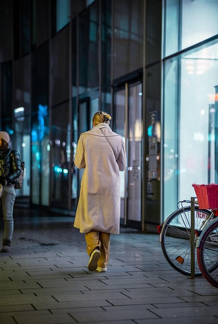 woman street building urban night blue eve coat person human everyday reflection lights mood city diverted