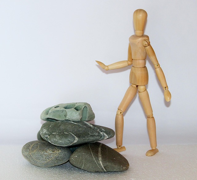 wooden figure resistance difficulties stones in the way stones obstacles struggle for life overcome get ahead find your