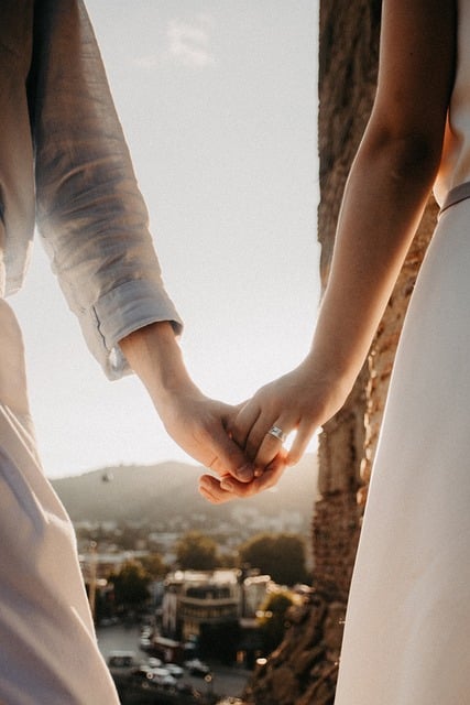 wedding couple wedding ring holding hands romantic city light love man woman sunset portrait friendship togetherness int