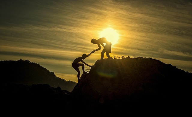 sunset men silhouettes helping helping hand adventure height climbing mountain peak summit help teamwork support assista